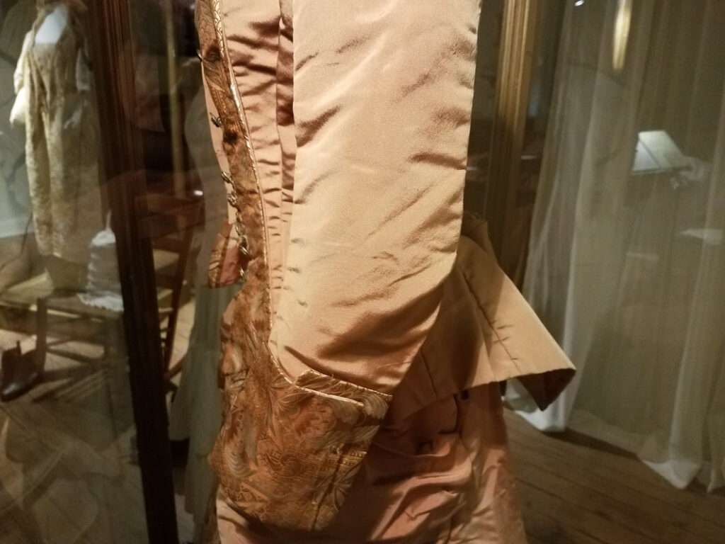 Side view of fitted Victorian gown bodice and sleeve