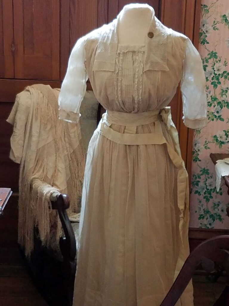 Close view of antique Edwardian day dress bodice with tucks and decorative waistband