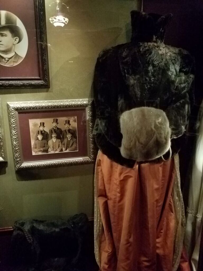 Victorian women's fur coat and large fur muff with rust colored skirt at Boot Hill Museum