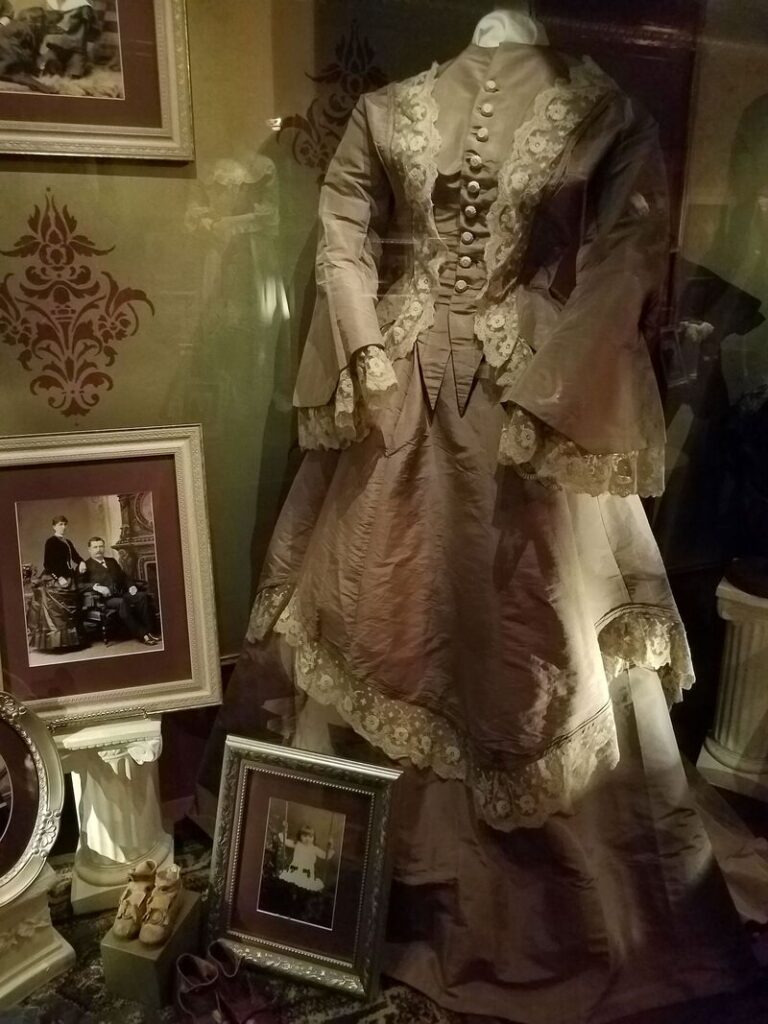 Elaborately trimmed Victorian bustle dress with lace and fitted bodice at Boot Hill Museum