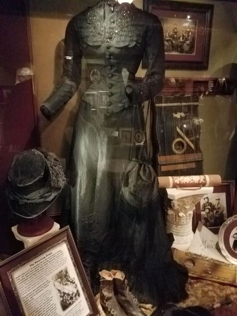 Historic Victorian mourning dress with hat and accessories at Boot Hill Museum